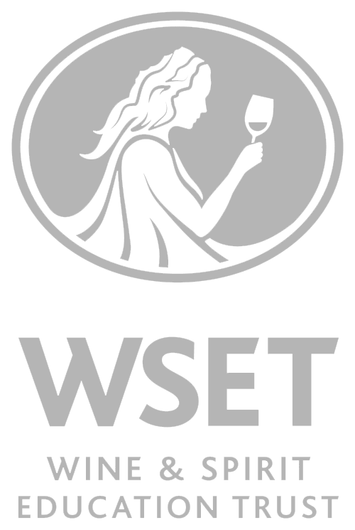 Logo of the Wine and Spirit Education Trust featuring a silhouette of a woman holding a wine glass.